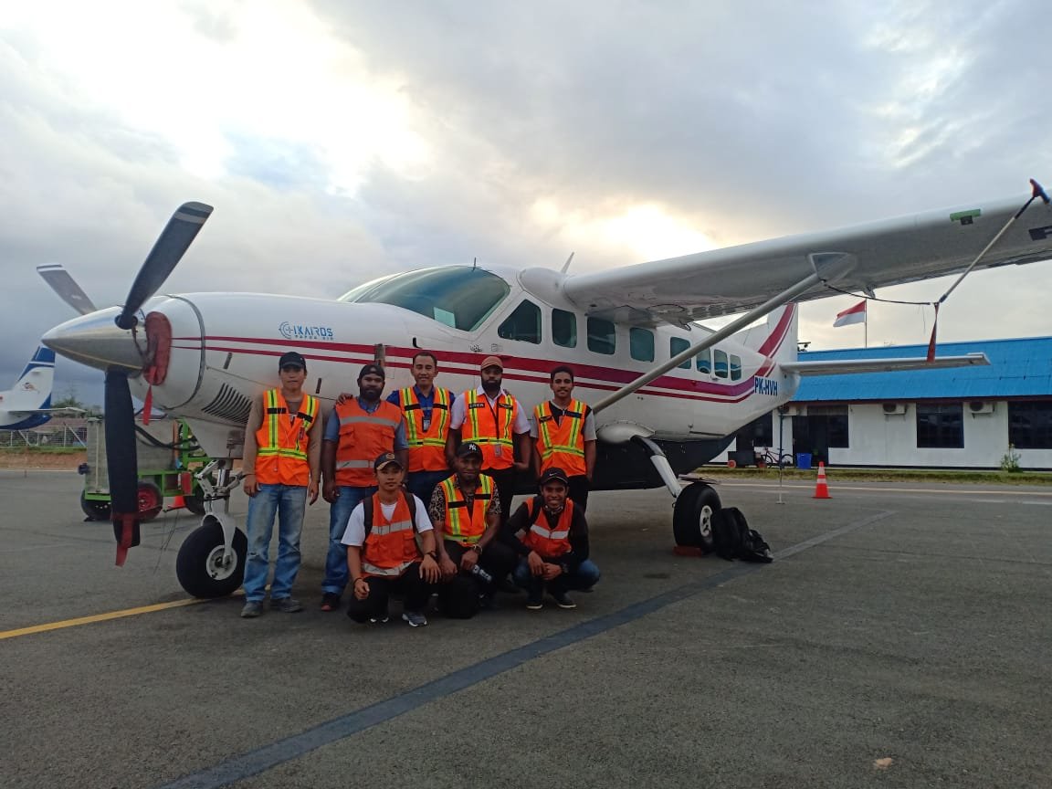 PT Ikairos Air Services crew in front of a Cessna Grand Caravan in Papua
